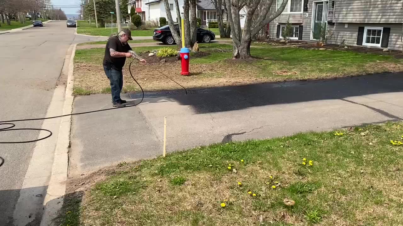 Professional Asphalt Spray Sealing: “The Tiny White Shed One” Top Coats Pavement Maintenance