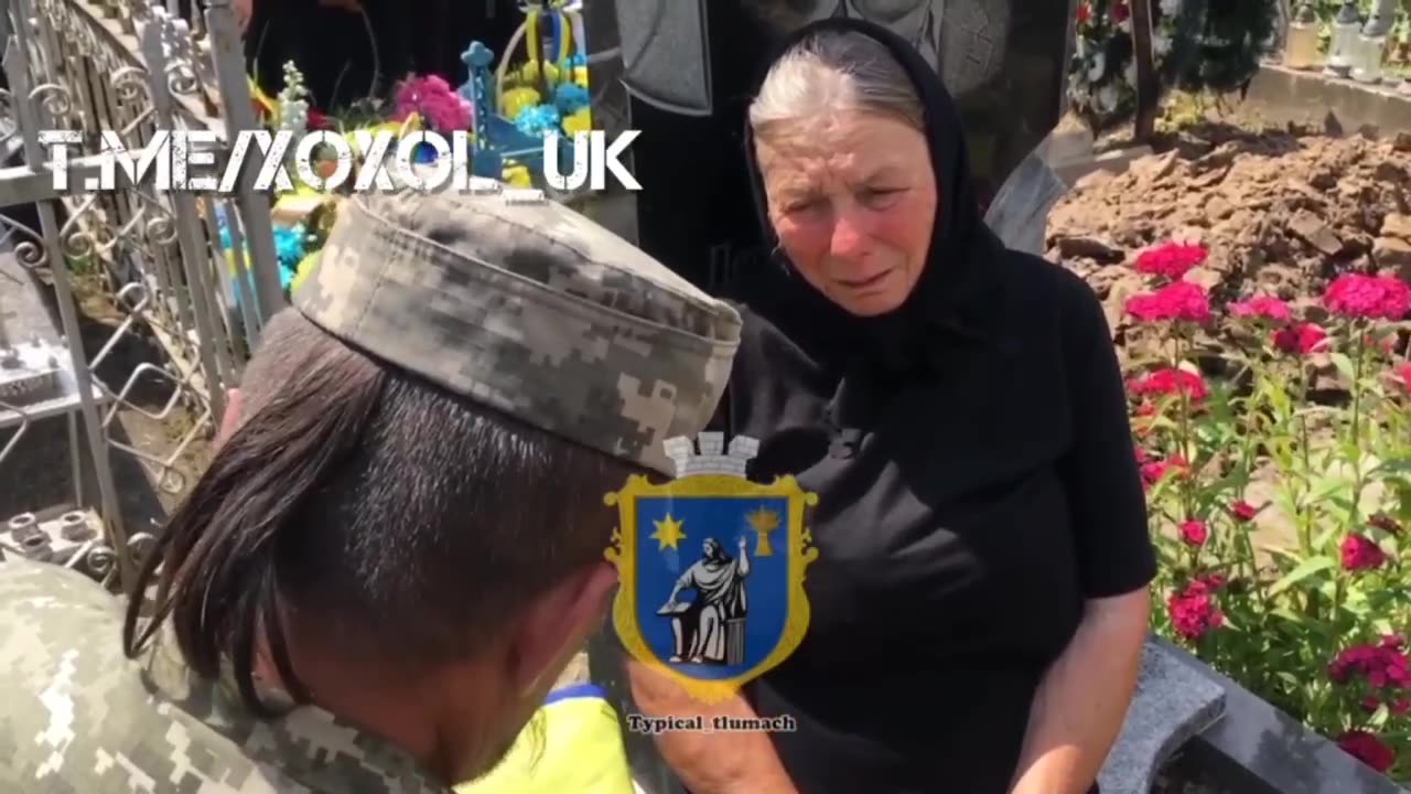 Ukrainian Rambo with a ponytail hands out a piss-and-tear flag to a poor woman