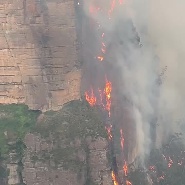 Fire in Australia filmed hugging cliffside like 'lava waterfall'