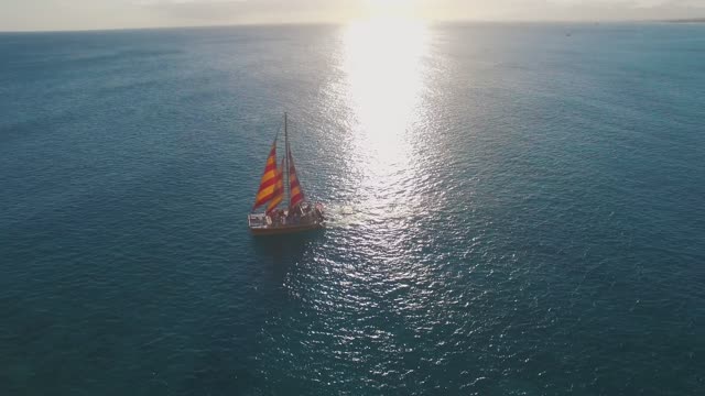 a sailboat traversing the deep sea