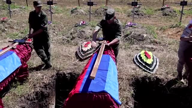 Pro-Russian separatists in Luhansk bury soldiers