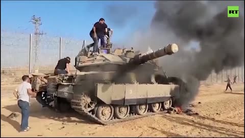 Israeli tank on fire as Palestinians cross border in the south of the country