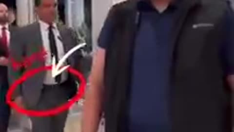 Trudeau being led by a US Marshall into the elevator？