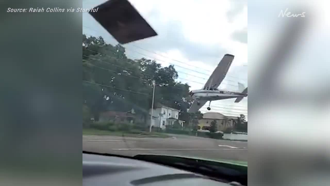 Plane crash lands on busy street, narrowly missing oncoming vehicles