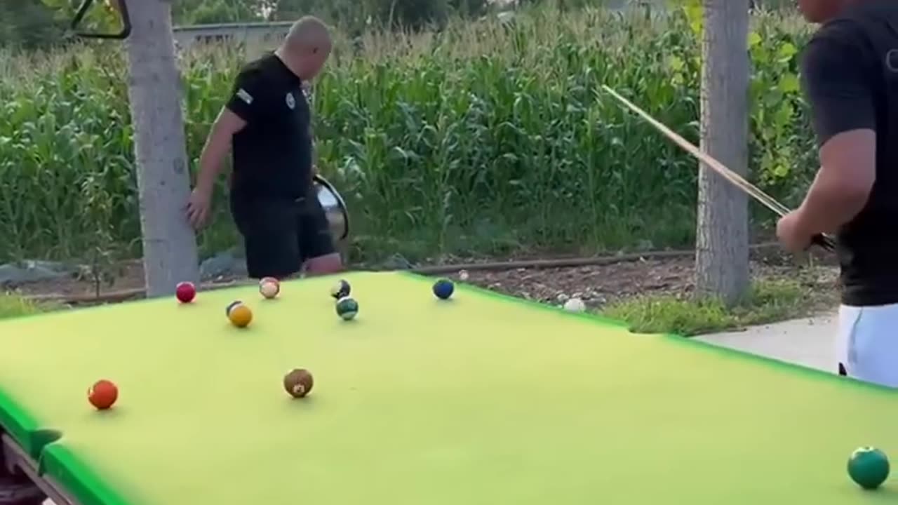 Two men funniest playing in billiards