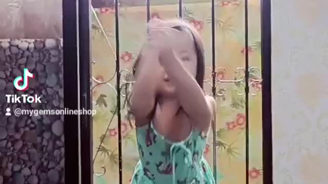 Little girl dances at the window