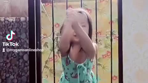 Little girl dances at the window