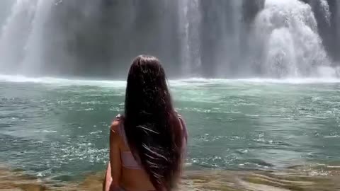 Girl and a beautiful waterfall