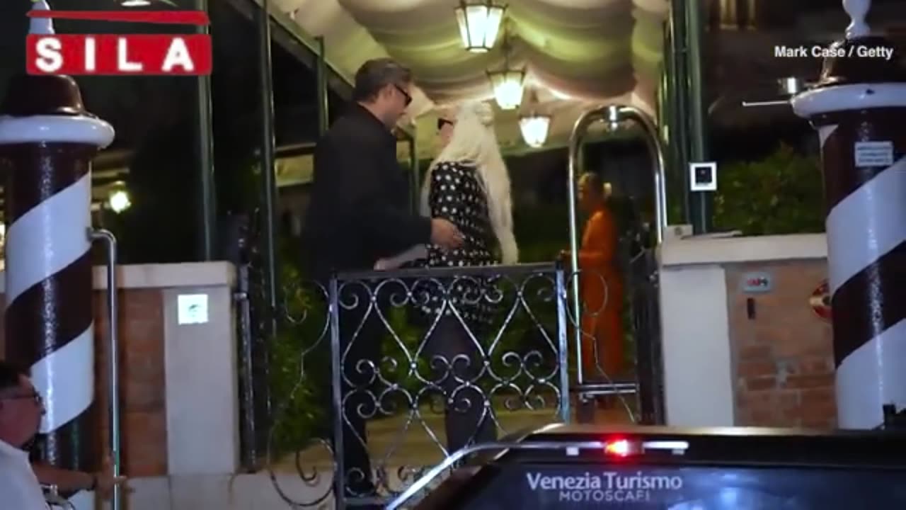 Lady Gaga looks chic in polka dot mini dress as she plants a kiss on fiancé Michael Polansky