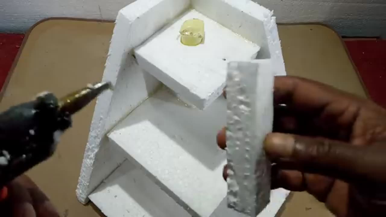 Homemade styrofoam and cement mini water fountain water fall