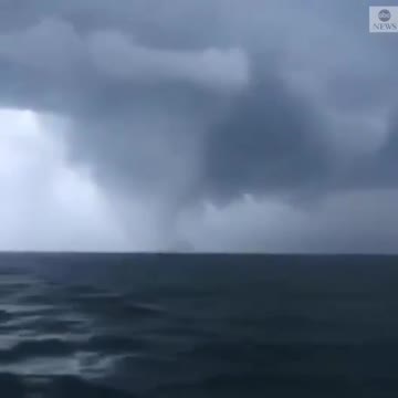 A huge waterspout was spotted, accompanied by dark clouds, as it churned over the Baltic Sea.