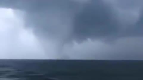 A huge waterspout was spotted, accompanied by dark clouds, as it churned over the Baltic Sea.