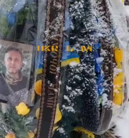 Ukraine mass grave for fallen soldiers (Bandera and Ukraine flags)