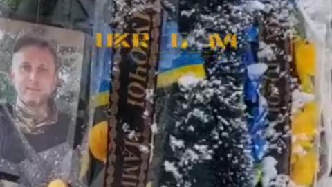 Ukraine mass grave for fallen soldiers (Bandera and Ukraine flags)