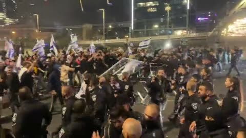 Israeli police clash with protesters as they attempt to clear the Ayalon Highway in Tel Aviv.