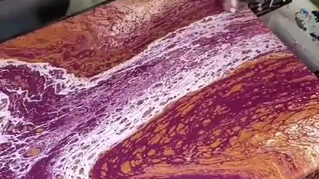 Person Creates Beautiful Patterns On Canvas By Pouring Paint On It