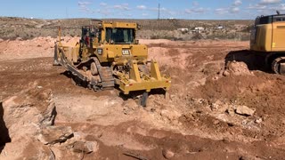 Dozer pulling boulders out of fill￼