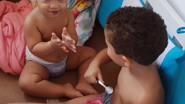 Boy Caught Giving Yogurt to His Little Brother