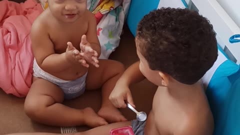 Boy Caught Giving Yogurt to His Little Brother