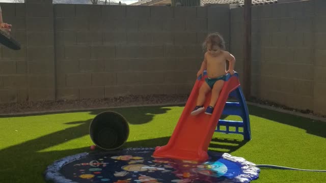 Isabella goes down slide by herself