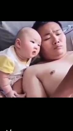 cute baby.. it's really serious watching games played with dad