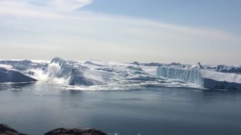 Ilulissat Icefjord - Large iceberg breaking over