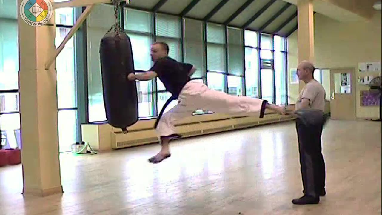 focus-pad-flying-left-side-kick-and-left-high-punch-front-view