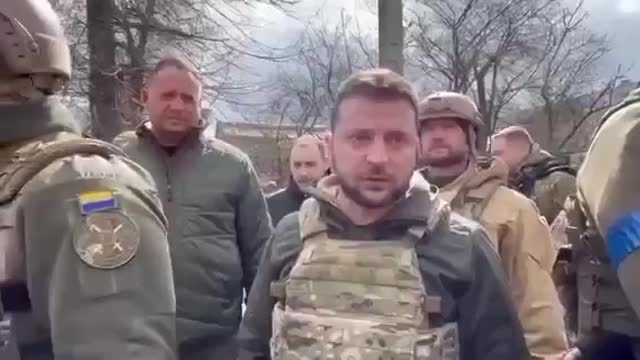 Hands in pockets, Zelenskiy talks about the irrecoverable loss of Mariupol to Russian forces...but who's the guy to his right?