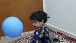 Charming child playing with balloons