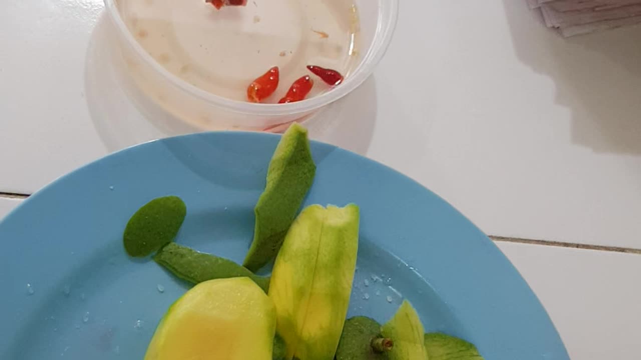 Green mango with funny face