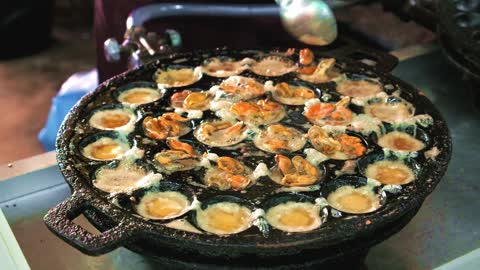 Fried Egg With Mussels Cooking In Iron Pan