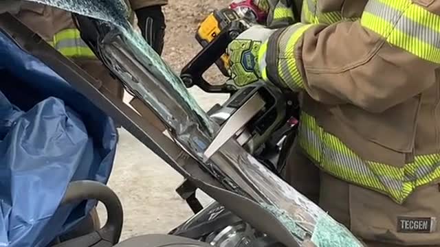 Firemen break down the accident car