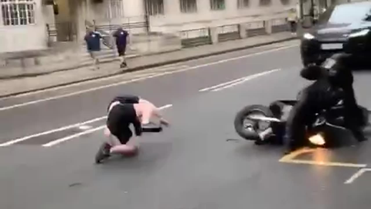 guy laughs at drunk dude trying to cross road as he is cleaned up by motorbike