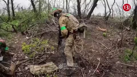 Fighters of the 3rd brigade display how they opened fire and entered Russian trench