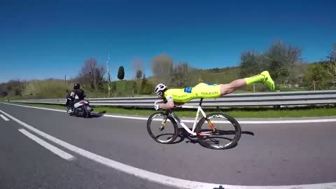 Italian cyclist Michael Guerra adopt a “plank” position and overtake his competitors