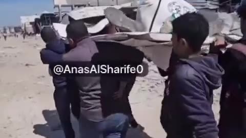 Palestinian youths carry the body of a young man who was killed by Israeli forces