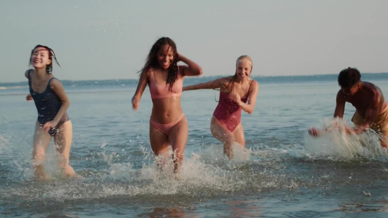 Fun time at the beach with friends in bikinis