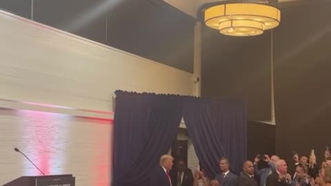 Trump enters to a room full of applause