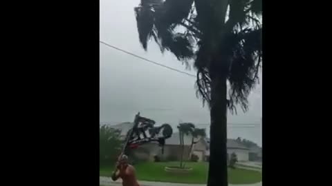 F Biden flags flying during hurricane Ian