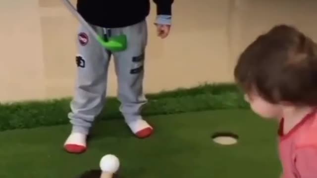 Kids playing golf