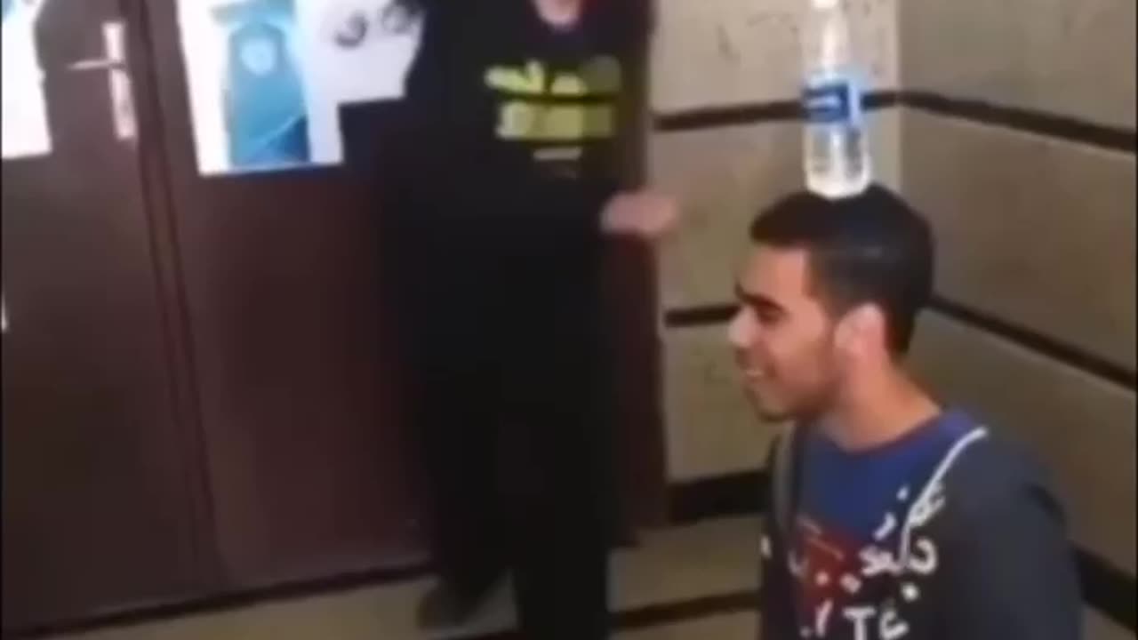 brave man lets girl kick bottle off his head, doesn't end well.
