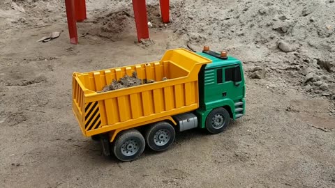 RC dump trucks will unload sand while walking across the bridge