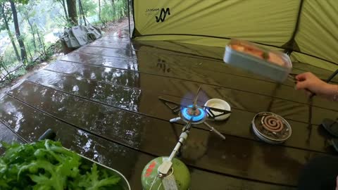 Camping outdoors in light rain. Camping time for rice farmers