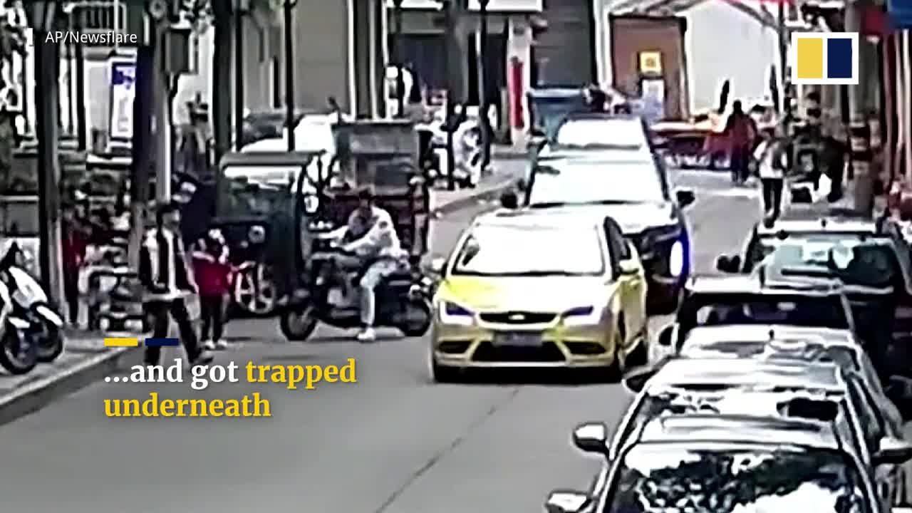 Chinese passers-by lift car up to free trapped boy