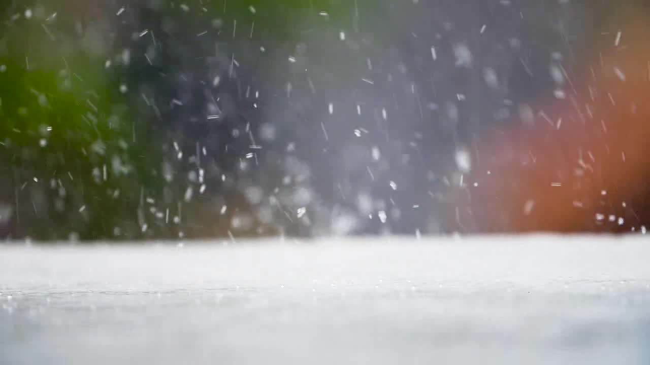 Close Up Shot of Rain Falling On Road Surface