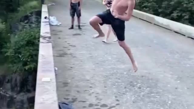 Man doing best parkour skills while jumping from bridge