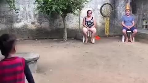 Small child football kicks perfect shot on parents heads