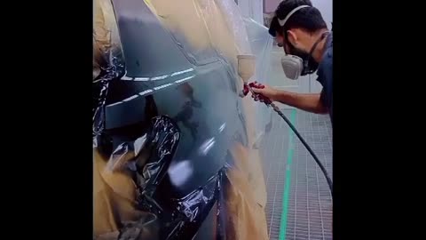 Car painted with supry Gun in paint booth