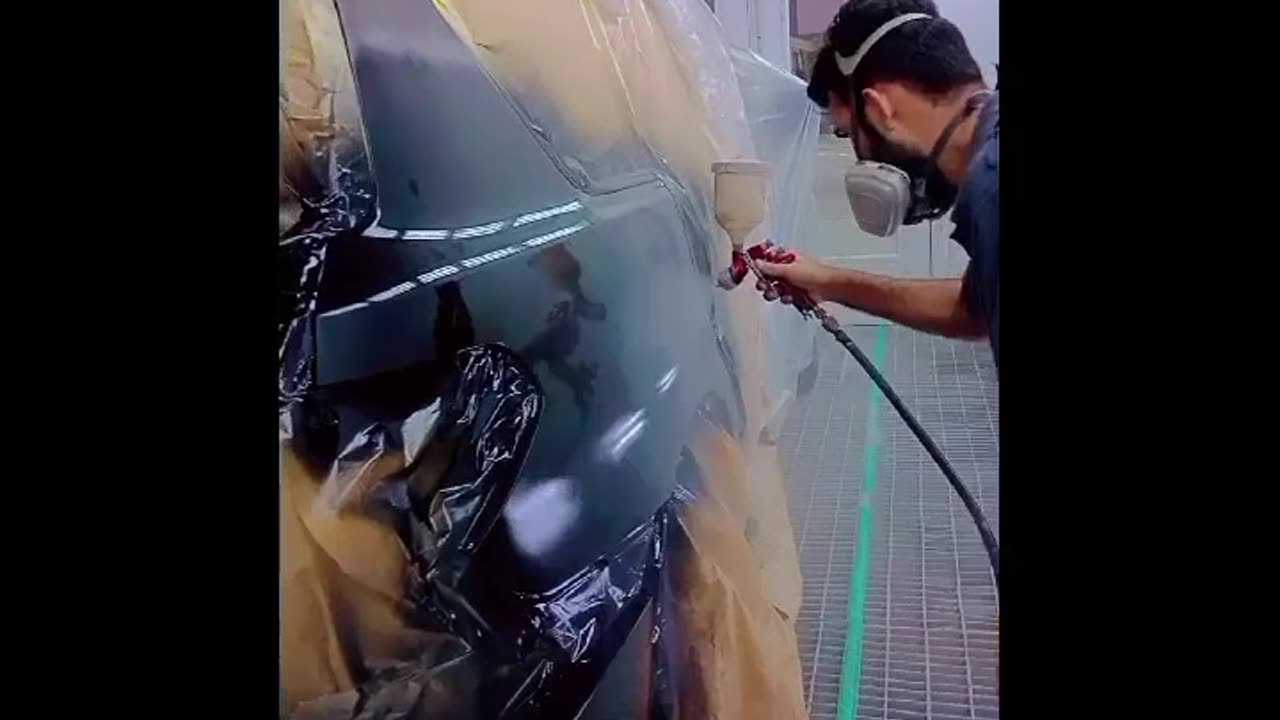 Car painted with supry Gun in paint booth