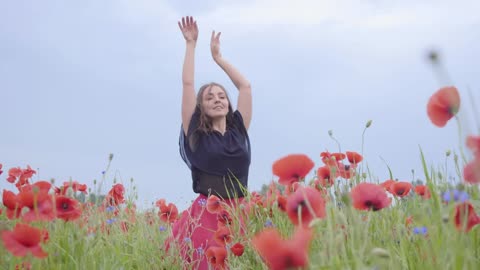 Girl dancing happily in a field of flowers